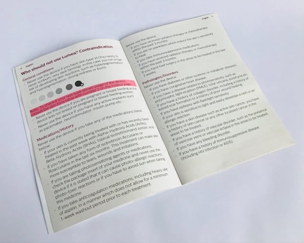Photo of the Lumea Prestige user manual open at the contraindications page