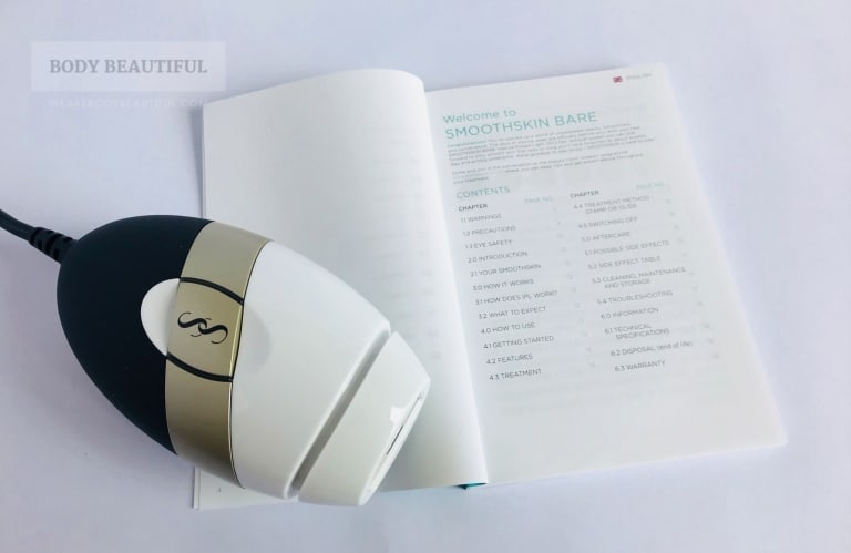 Photo of the user booklet open at the contents list next to the white, gold and black Bare.