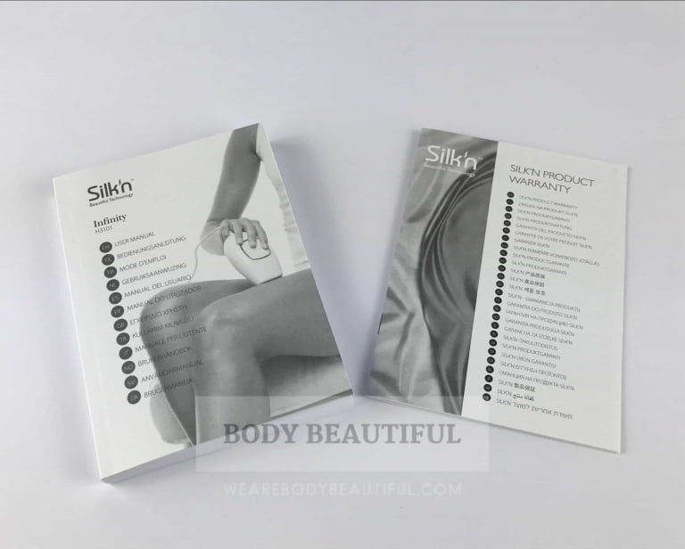 Photo of the small but thick multi-language instruction booklet and Silk'n warranty card.