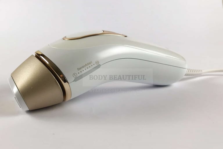 Angled side photo of the white and gold Braun Pro 5 IPL showing the subtle curves and clean design lines.