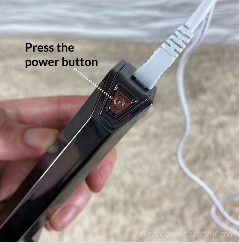 Press the power button on the end of the device